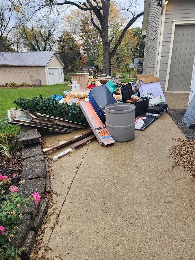 Dumpster being loaded with debris for Demolition Dumpster Rental in Baraga